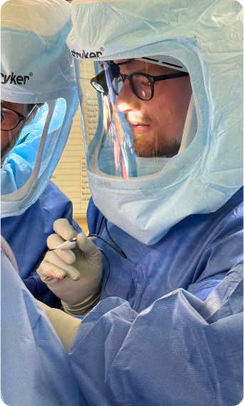 Dr. Josiah Valk performing orthopedic surgery in a hospital operating room