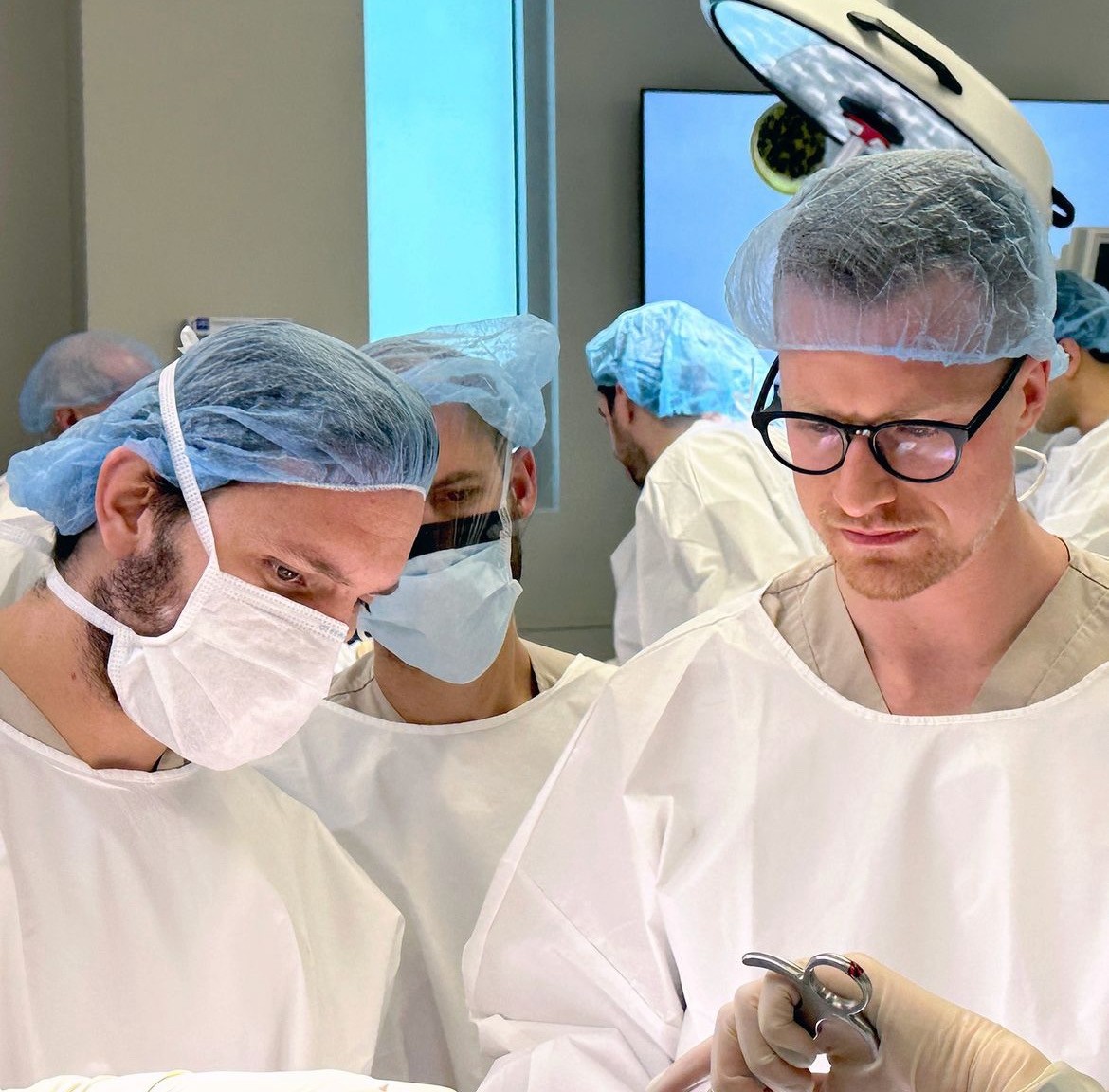 Dr. Josiah Valk performing orthopedic surgery in a hospital operating room